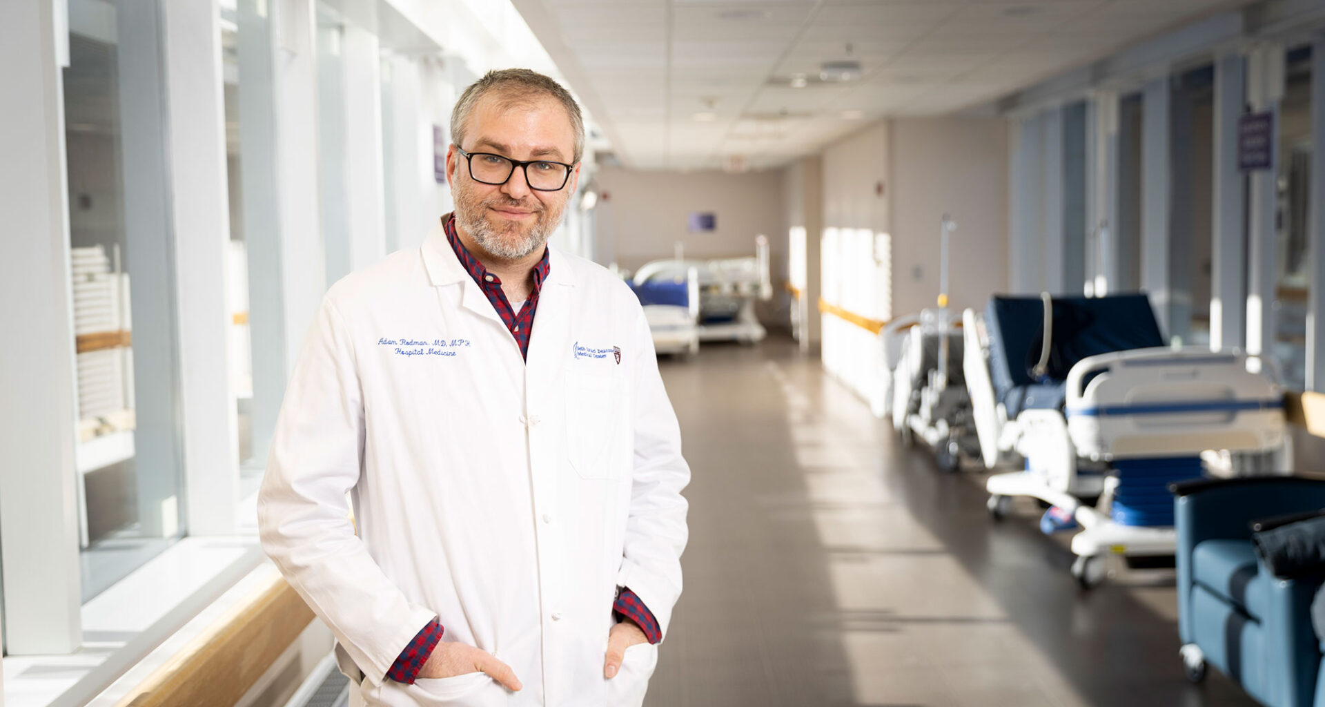 Adam Rodman standing in hospital corridor.