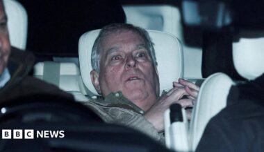 Andrew Mountbatten-Windsor slumped in the back seat of a car