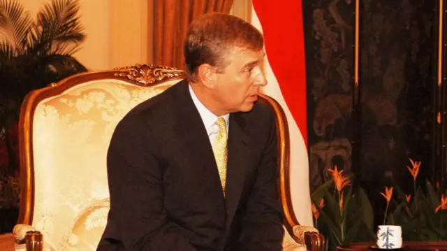 Andrew Mountbatten-Windsor sitting on a chair speaking to someone out of frame in 2007