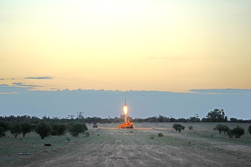 A small rocket commences a launch in outback Australia
