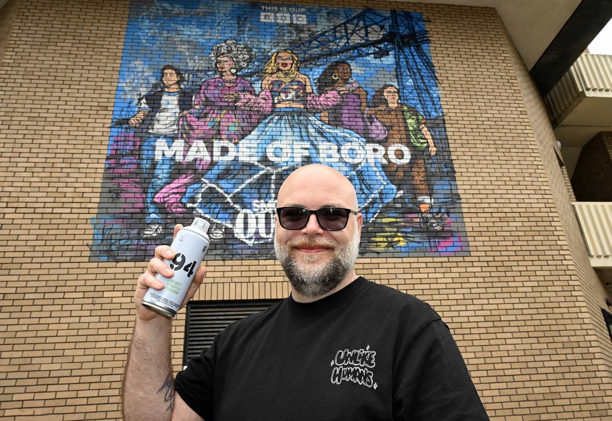 Mural artist Stephen Irving at his creation.