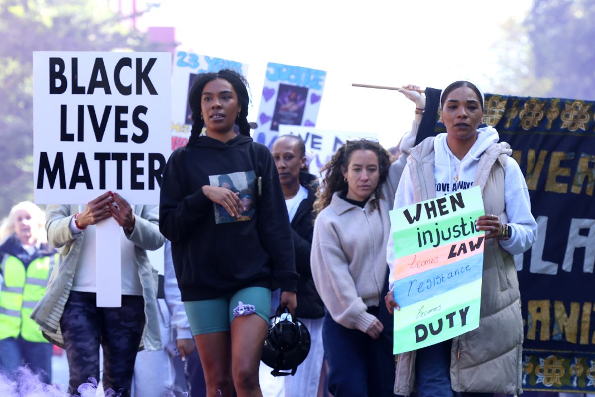 A protest march for Lain Estridge makes its way from Grove Street