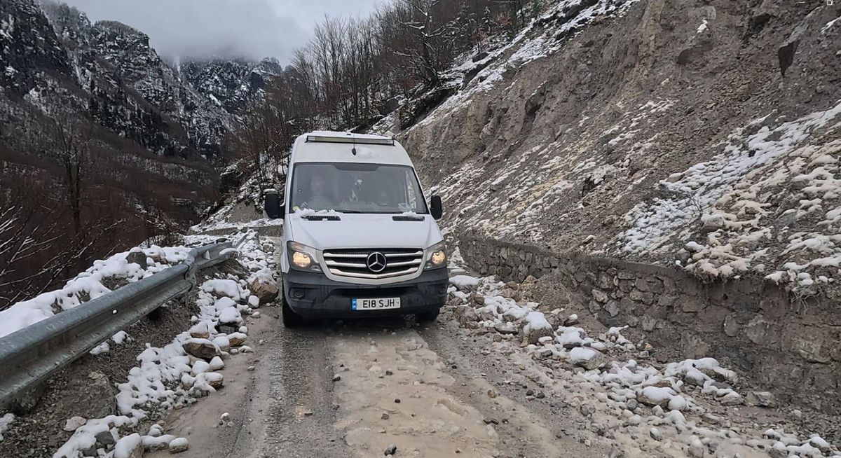 A van on a snowy narrow track