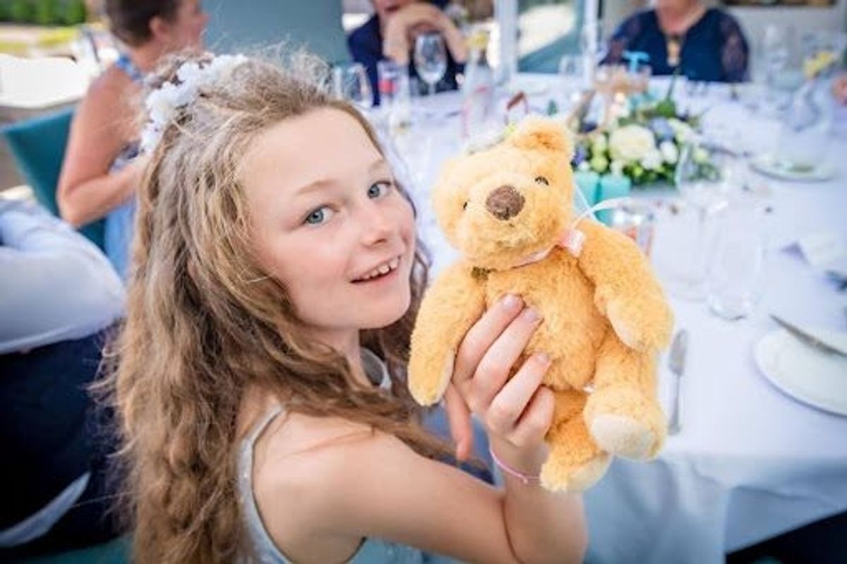 young girl holding teddy bear