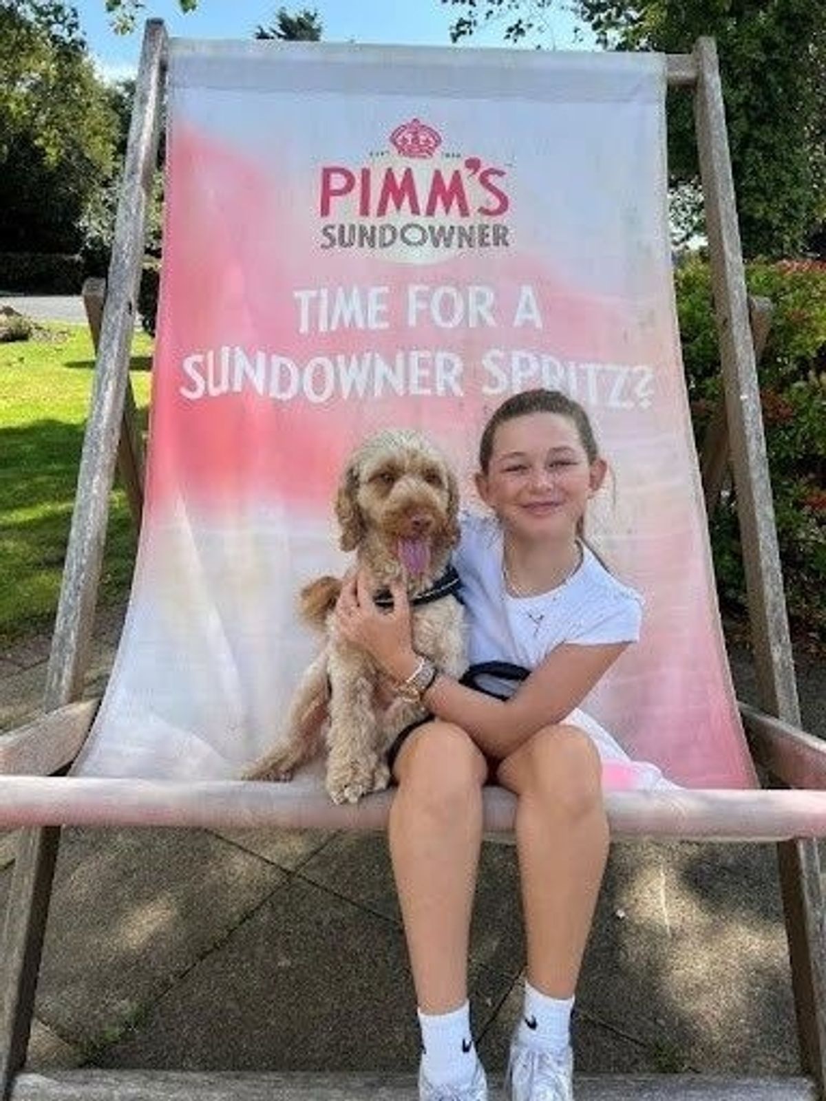 girl sat with dog on deckchair
