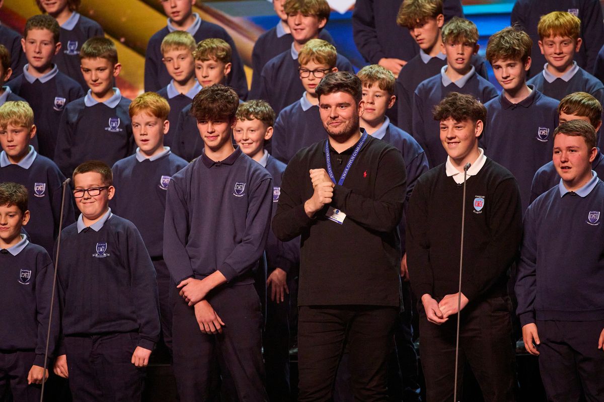 Lloyd Macey on stage with the choir