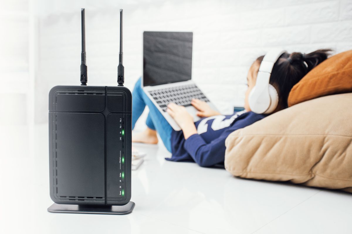 Wireless router and kids using a laptop in home