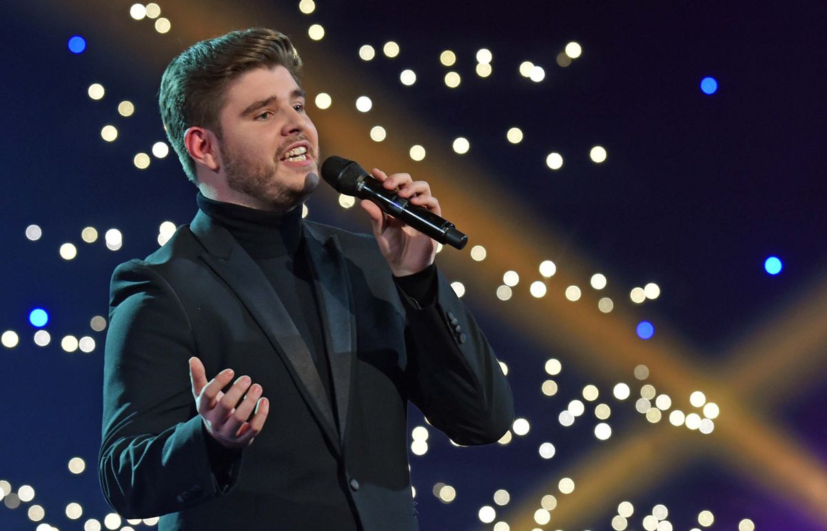 Lloyd Macey Carolau from Llandudno performing at Venue Cymru with lights in the background