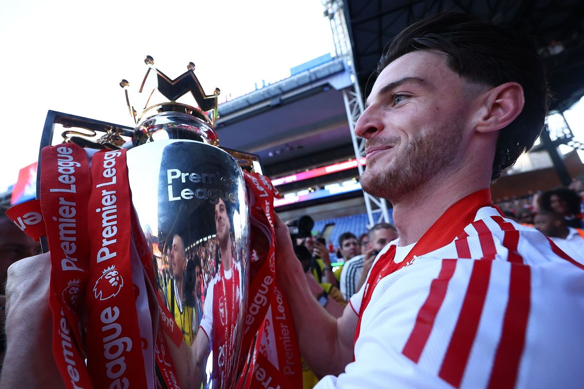 Declan Rice of Arsenal holding Premier League trophy