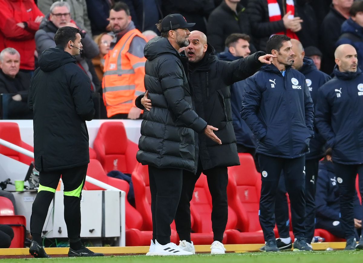 Jurgen Klopp and Pep Guardiola exchange words during the Premier League match between Liverpool FC and Manchester City at Anfield on October 16, 2022