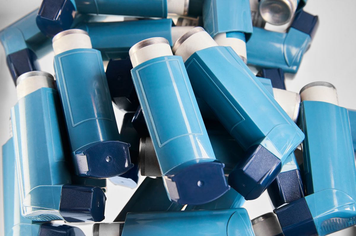 Blue of asthma inhalers on white background.