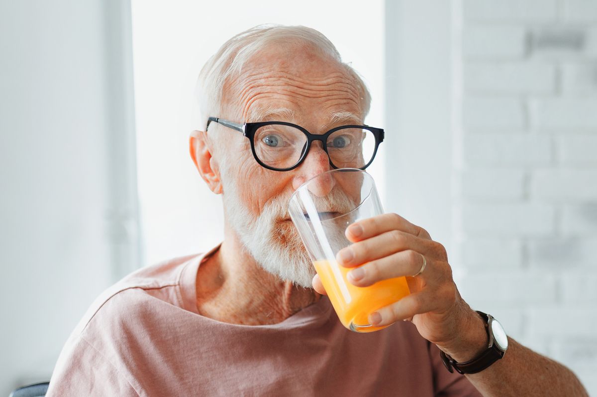 Man drinking orange juice