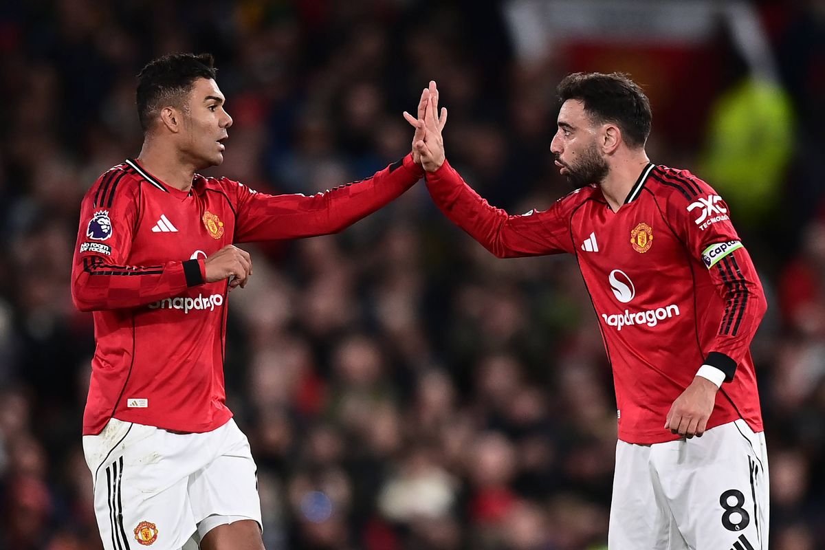 Casemiro of Manchester United celebrates scoring a goal to make the score 1-2 with Bruno Fernandes (R) during the Premier League match between Manchester United and Leeds United at Old Trafford on April 13, 2026 in Manchester, United Kingdom