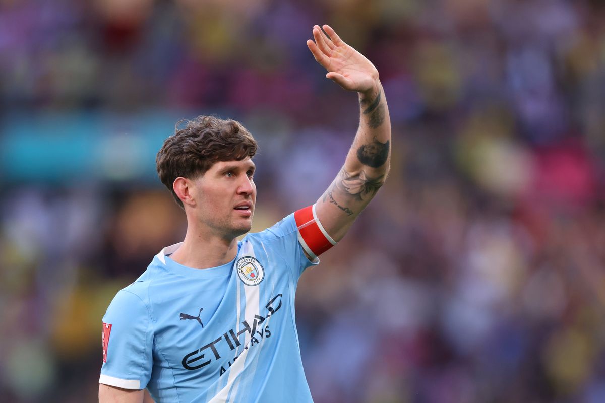 Man City defender John Stones waves to the crowd.