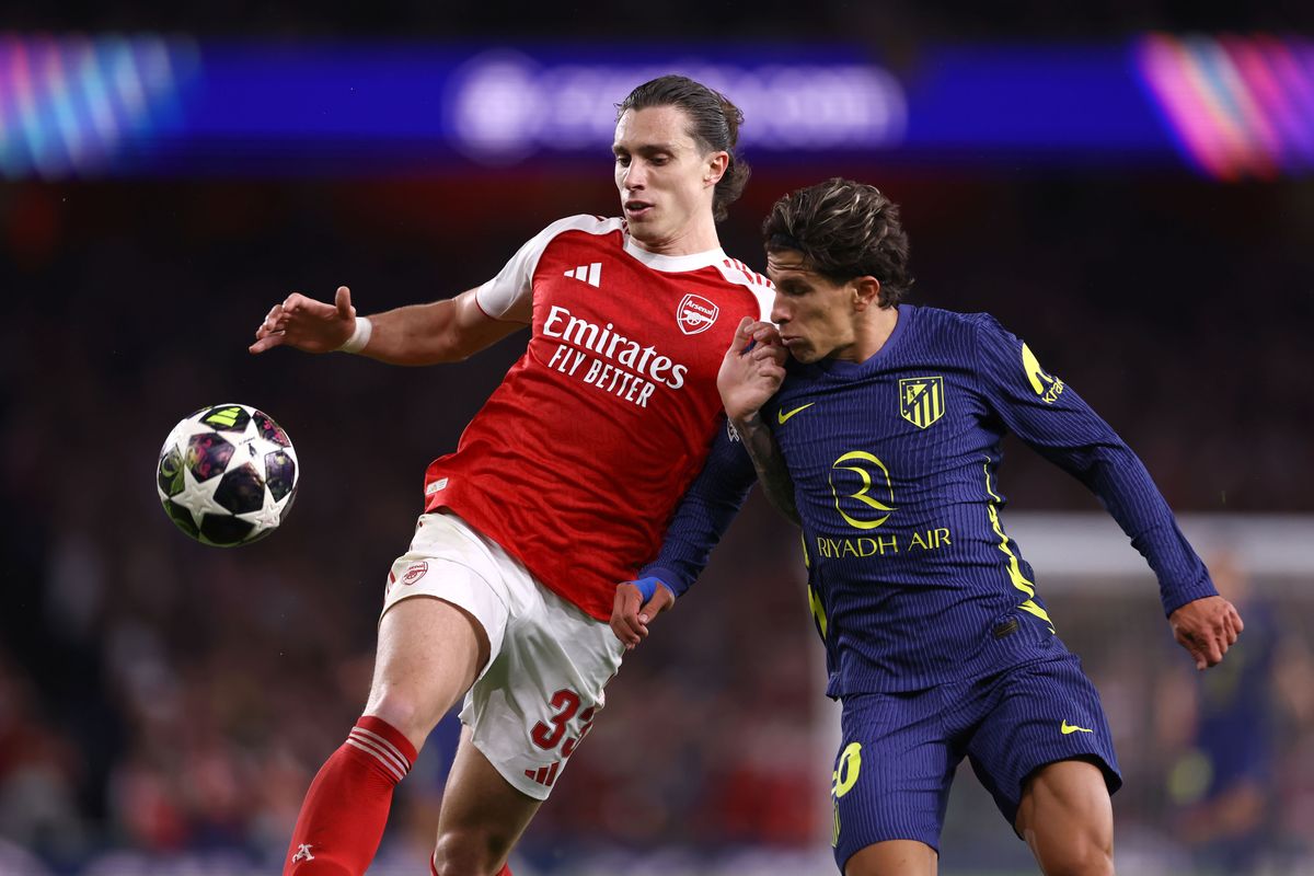 Riccardo Calafiori of Arsenal and Giuliano Simeone of Atletico Madrid during the UEFA Champions League 2025/26 Semi Final Second Leg match between Arsenal FC and Atletico de Madrid