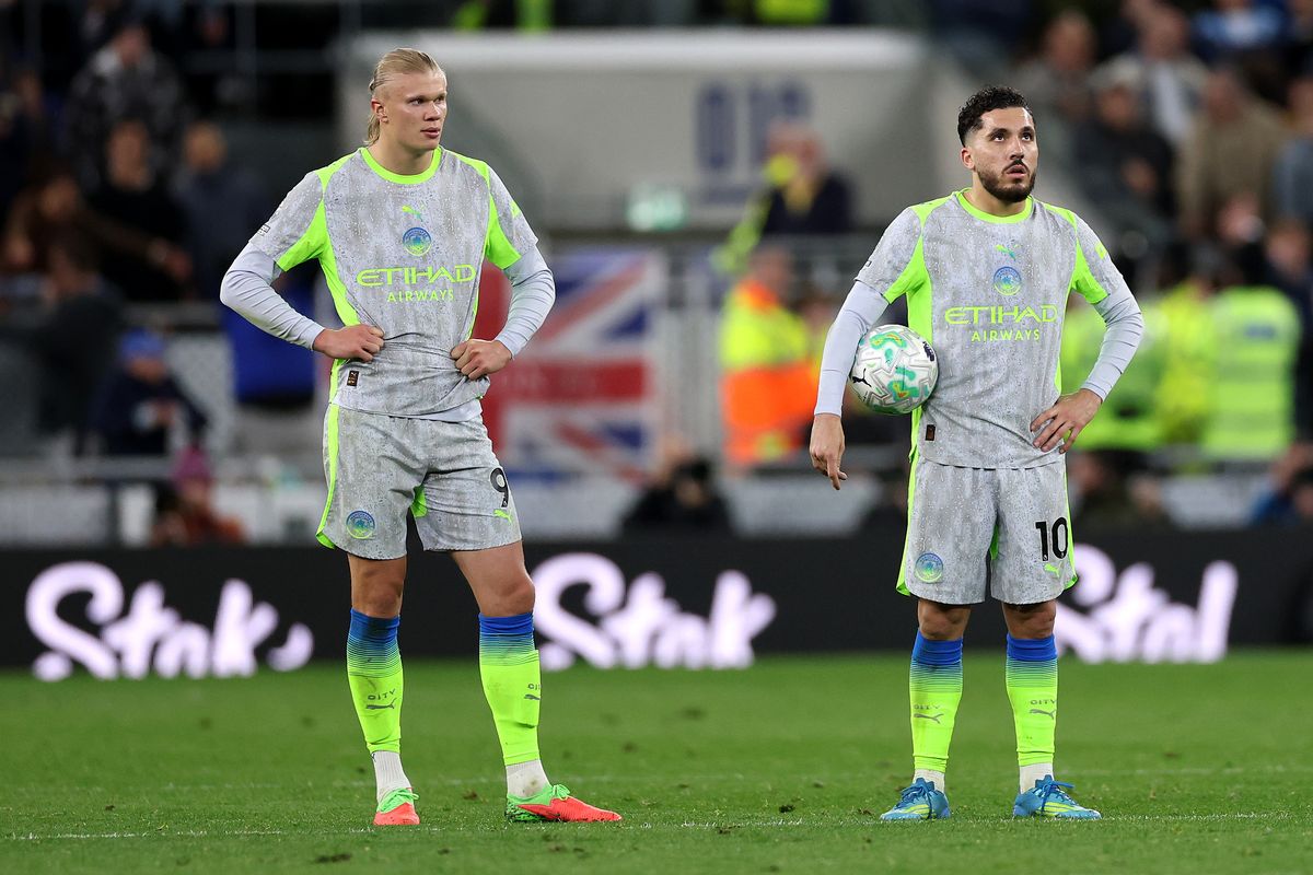 Erling Haaland and Rayan Cherki look on during a Man City game
