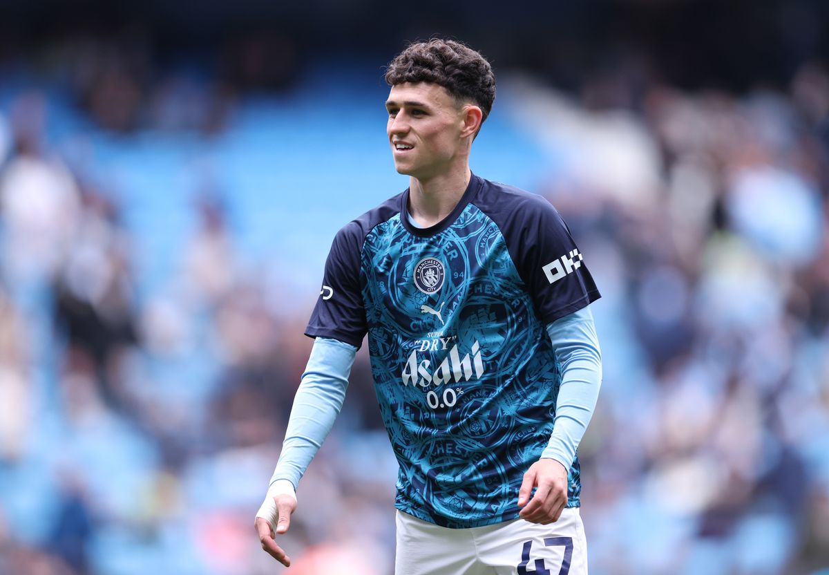 Phil Foden looks on during the warm up prior to the Premier League match between Manchester City and Brentford