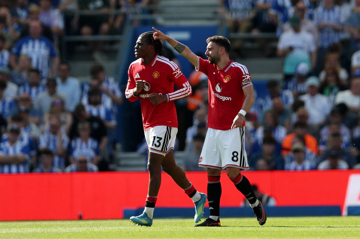 Patrick Dorgu of Manchester United celebrates scoring his team's first goal with teammate Bruno Fernandes during the Premier League match between Brighton & Hove Albion and Manchester United at the Amex Stadium on May 24, 2026 in Brighton, England.