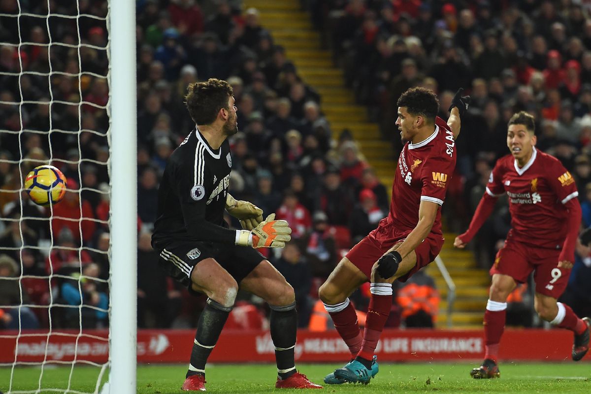 Liverpool's English striker Dominic Solanke (C) puts the ball in the net but it is disallowed for hand-ball during the English Premier League football match between Liverpool and West Bromwich Albion at Anfield in Liverpool, north west England on December 13, 2017