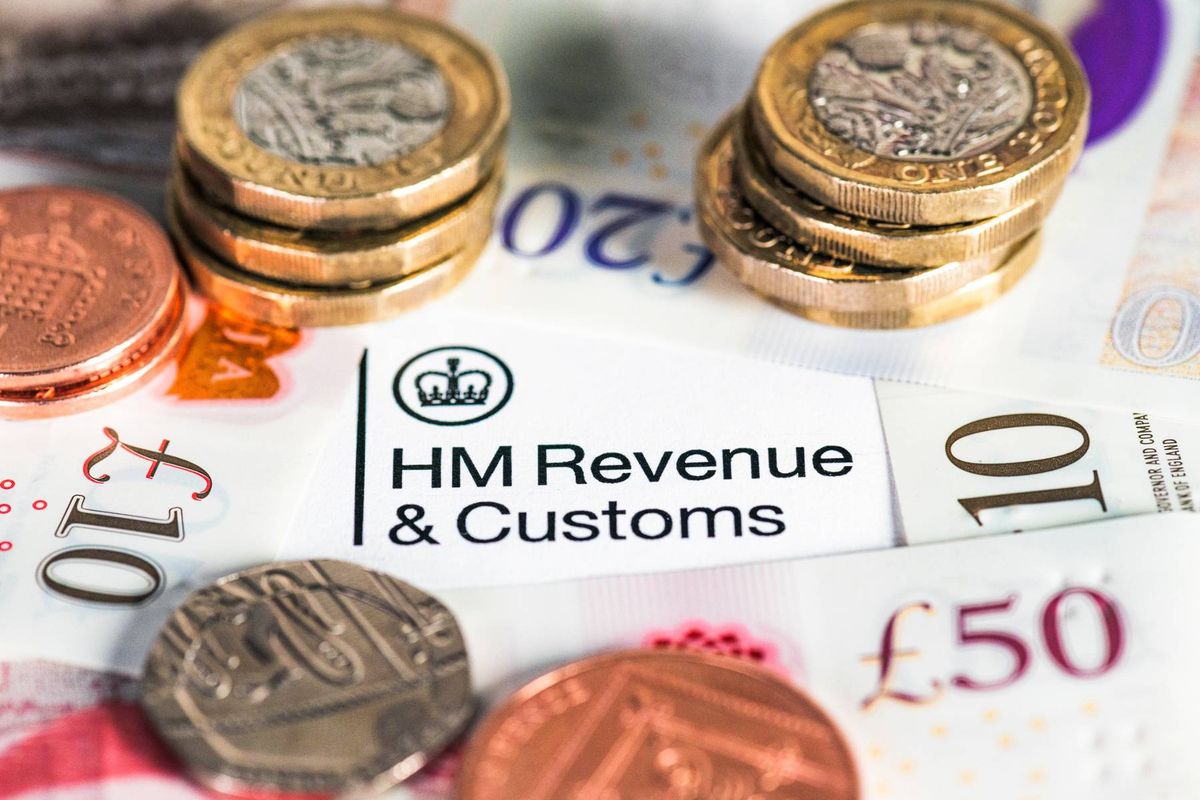 A collection of modern British banknotes surrounding the HM Revenue & Customs heading on a UK Government tax form.