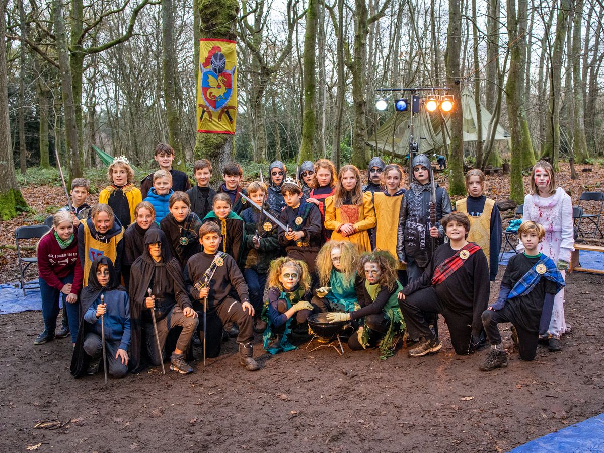 An image of Year 7 children from Highfield and Brookham Schools performing Macbeth in the woods in 2020