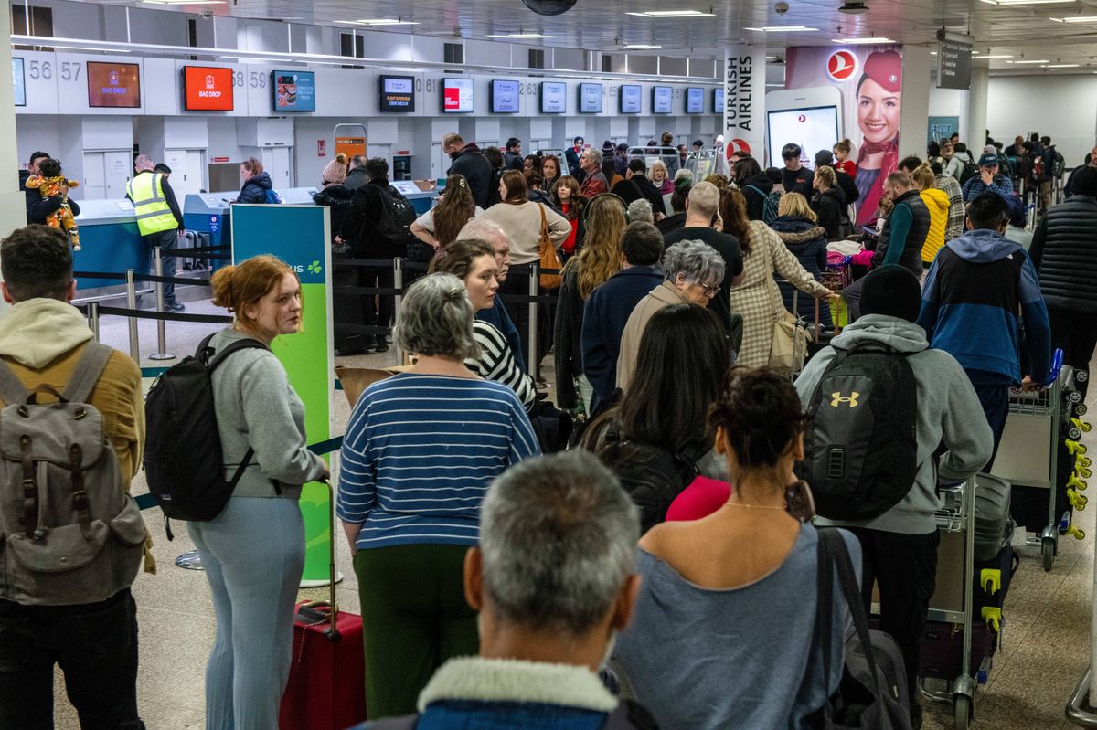 Airline passengers queue for check-in at Birmingham Airport Ltd. in Birmingham, UK, on Thursday, Dec. 21, 2023. The post-pandemic recovery of air travel is also gaining pace in China and India, while the US is expecting to see record travel demand during the holiday season. Photographer: Chris J. Ratcliffe/Bloomberg via Getty Images