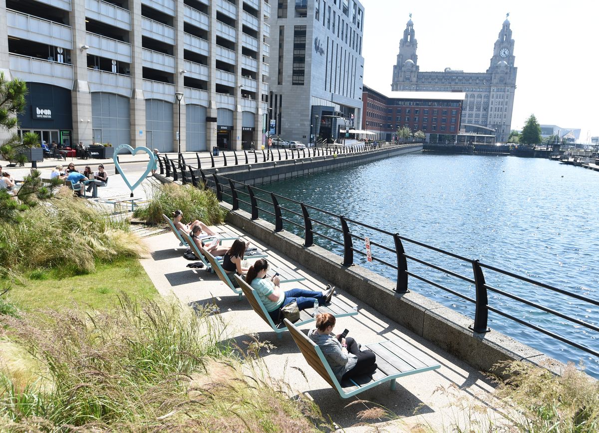 Workers relaxing in the sunshine in Princes Dock