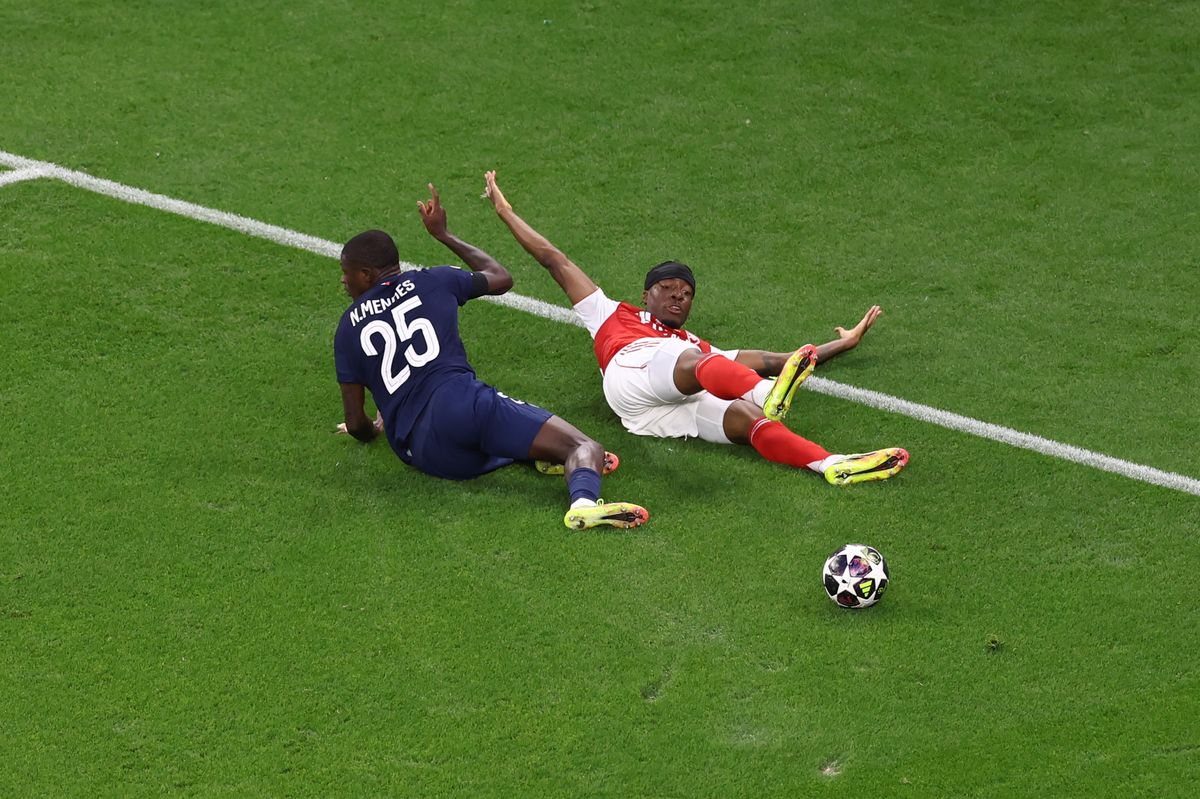 Noni Madueke of Arsenal appeals for a penalty after a challenge by Nuno Mendes of Paris Saint-Germain