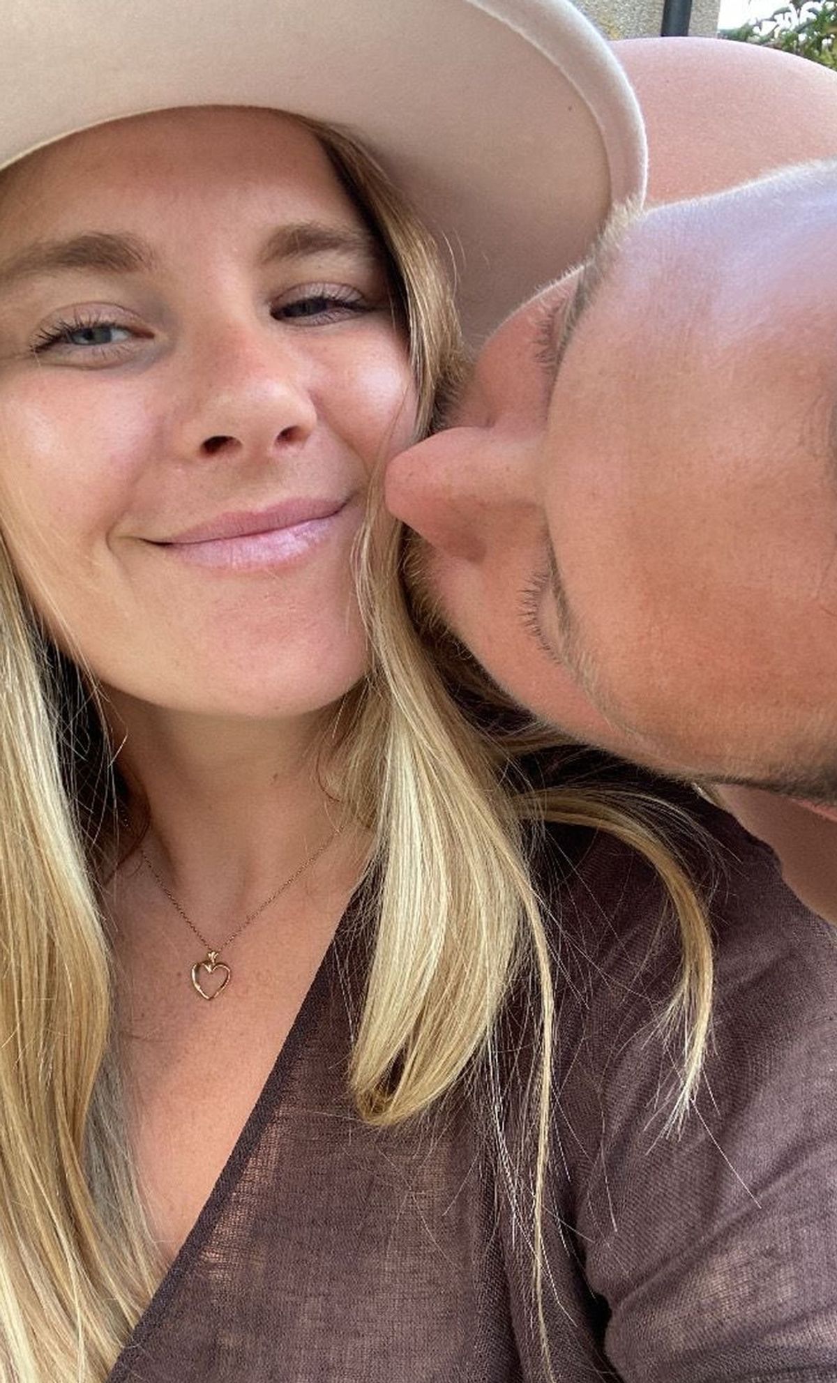 Sam kissing wife Georgia on the cheek