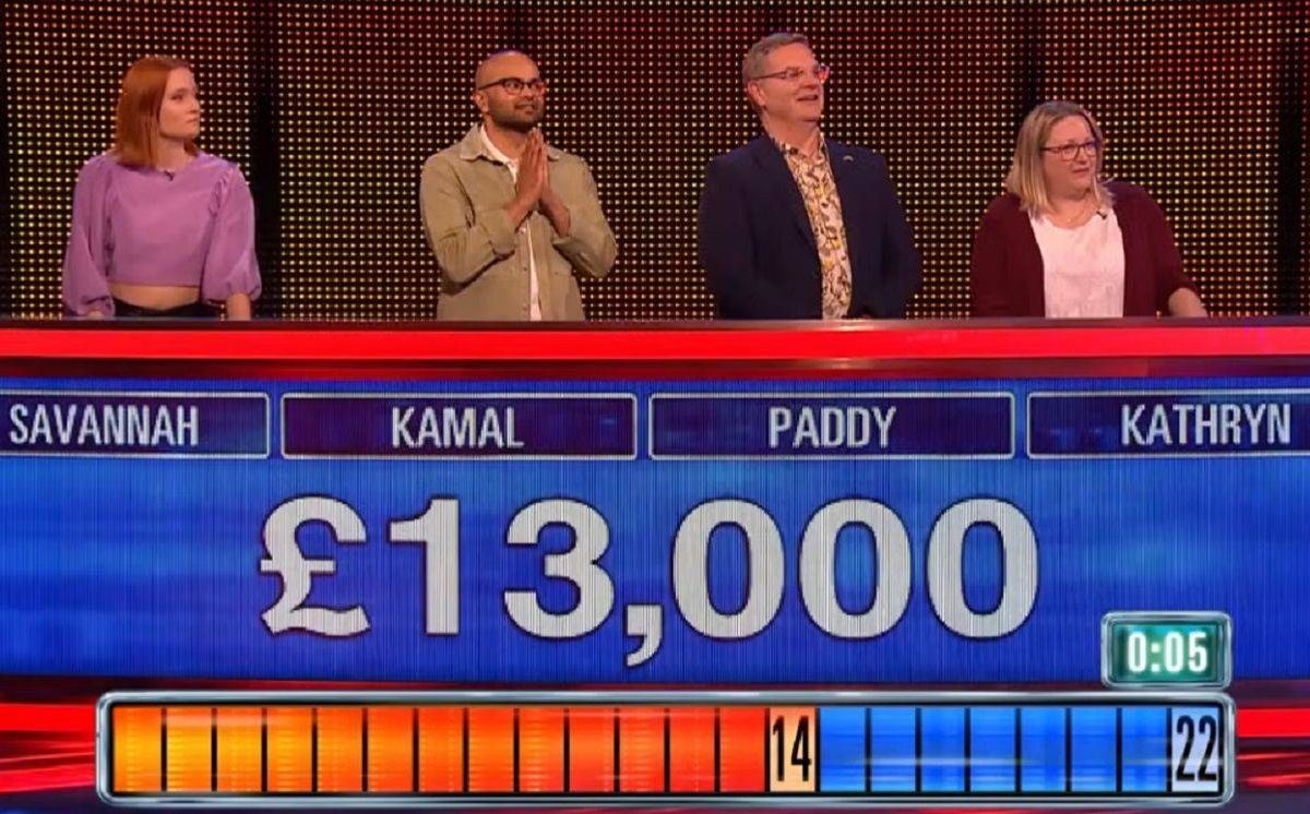 An image depicts a panel of four individuals seated in front of a scoreboard, which prominently displays the sum of £13,000.