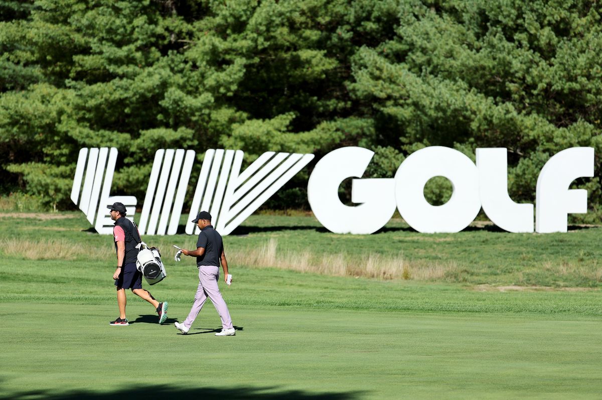 Anirban Lahiri walking past LIV Golf signage