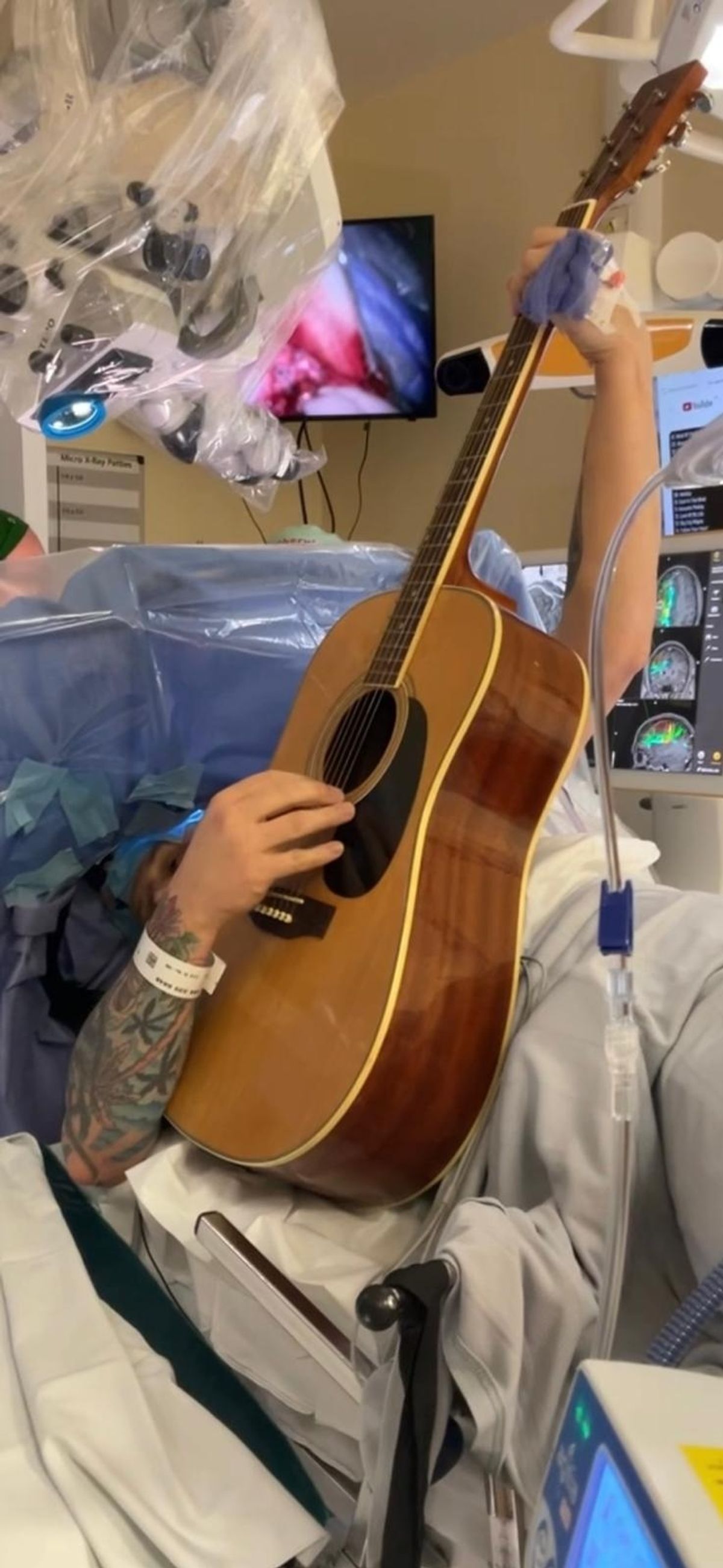 Paul was awake and playing the guitar as surgeons removed a malignant tumour from his brain