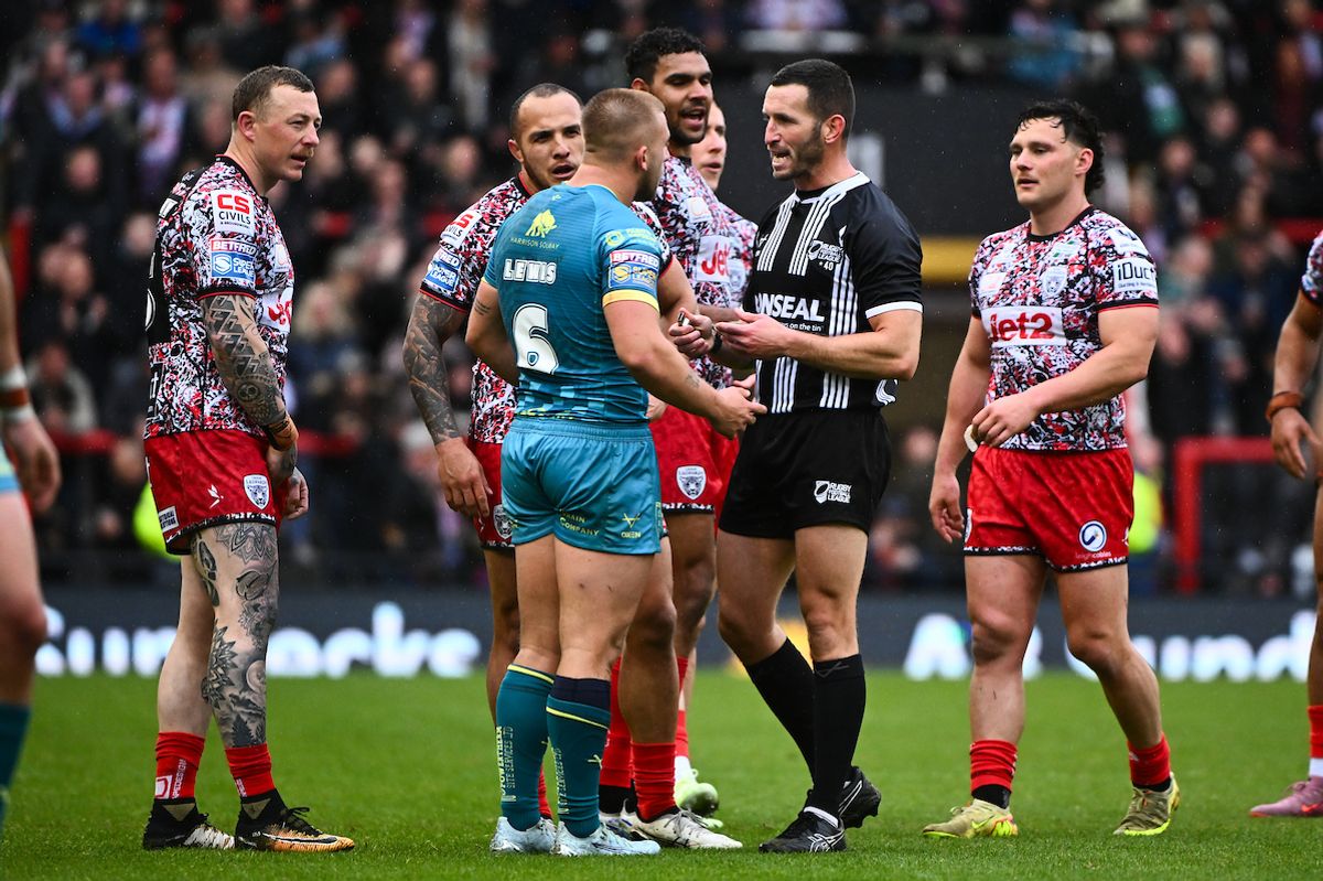 Referee Jack Smith showing a yellow card to Mikey Lewis of Hull KR