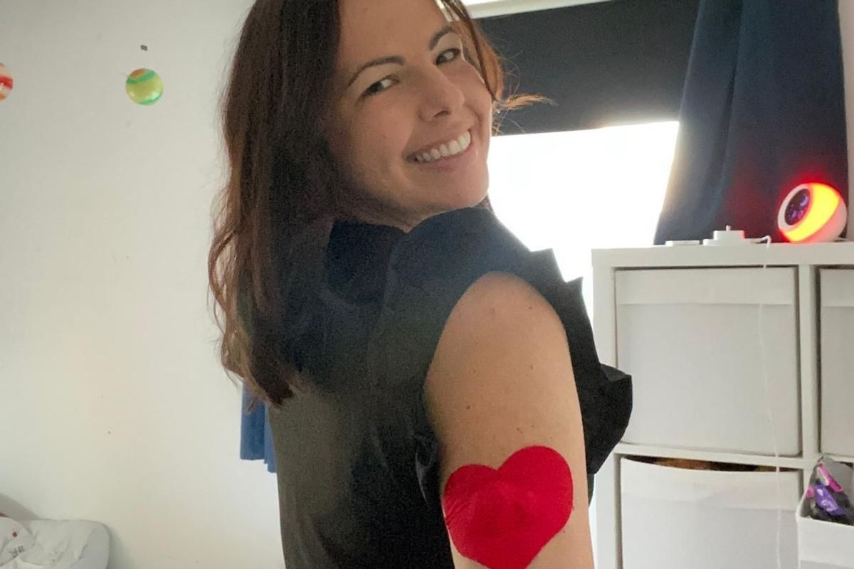 A woman pictured wearing a diabetes device