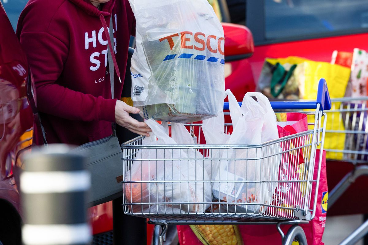 A customer loads bags from a shopping trolley to their car outside a Tesco Plc supermarket in Barkingside, London, UK, on Wednesday, Jan. 7, 2026. Tesco said profit for this financial year will likely be at the upper end of its forecast after strong sales during the crucial Christmas period. Photographer: Chris Ratcliffe/Bloomberg via Getty Images