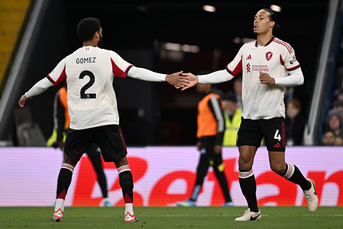 Virgil van Dijk of Liverpool celebrates scoring his team's first goal with teammate Joe Gomez during the Premier League match between Aston Villa and Liverpool at Villa Park on May 15, 2026 in Birmingham, England.
