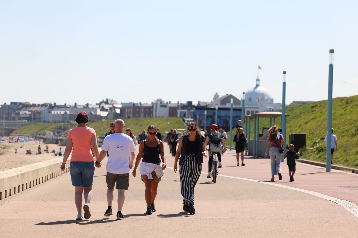 People enjoy the sunny weather in Whitley Bay.