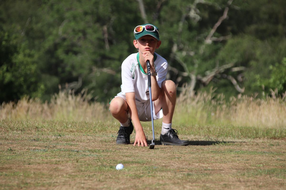 A young student at Highfield and Brookham playing golf in the school's very own 9-hole course