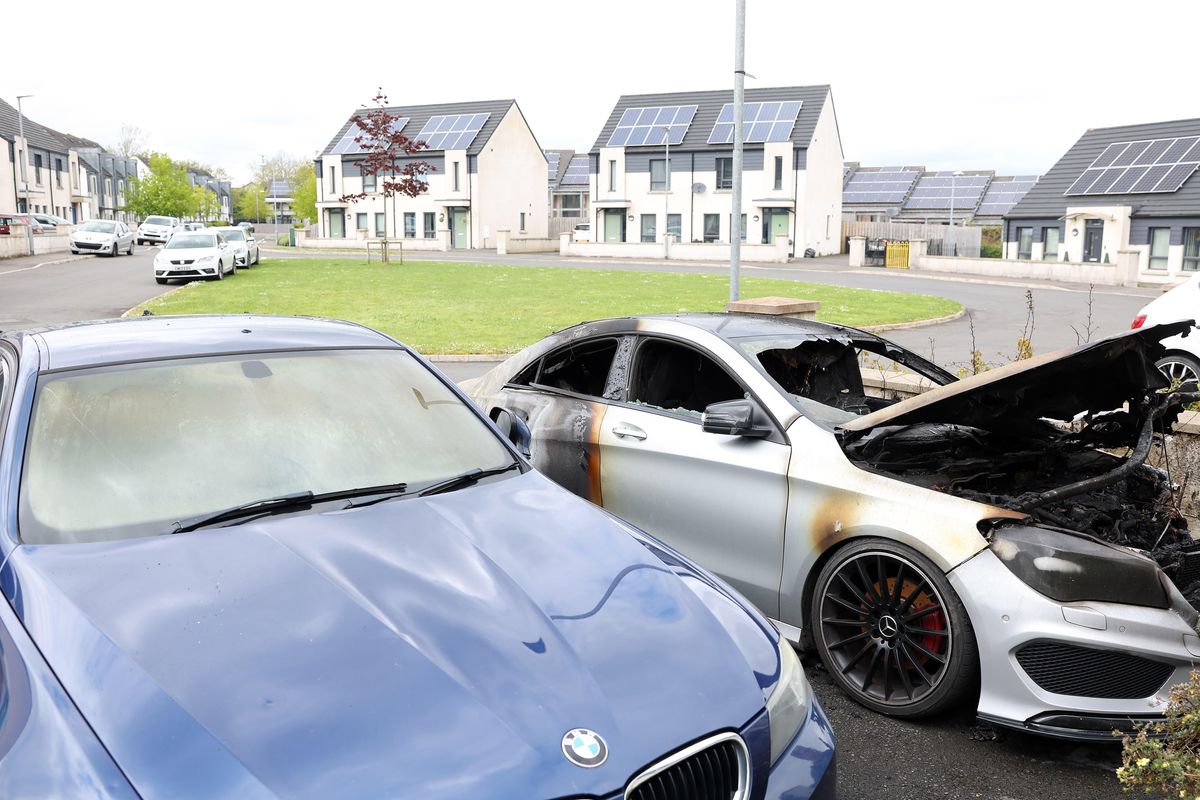 The scene at Killynure Green in Carryduff where police are investigating an incident of arson after two cars were damaged in a fire outside a house in the early hours of Wednesday morning.