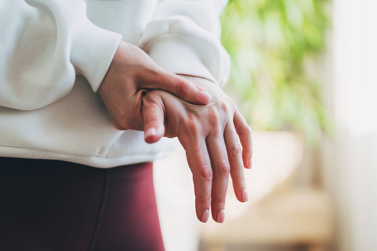 woman holding her wrist pain