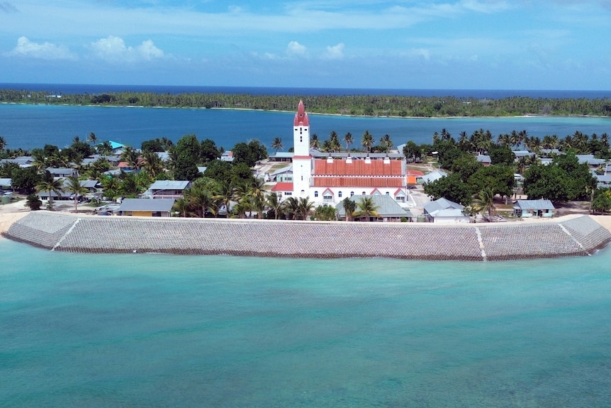 Protective sand barriers stand guard around the main church on the island of Nanumea.