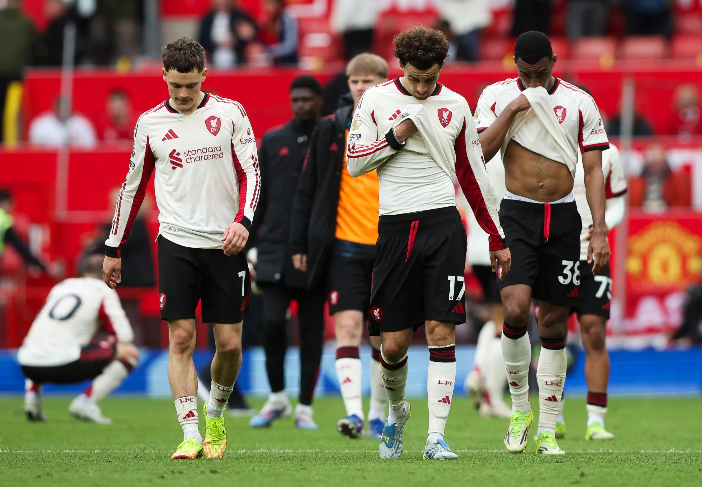 Curtis Jones and other Liverpool players look dejected at the end of the Manchester United v Liverpool FA Premier League match.