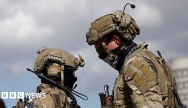 Two US military personnel dressed in camouflage
