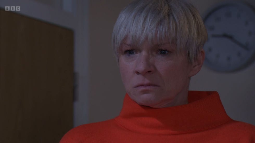 eastenders nicola mitchell wearing a red turtleneck with an angry look on her face