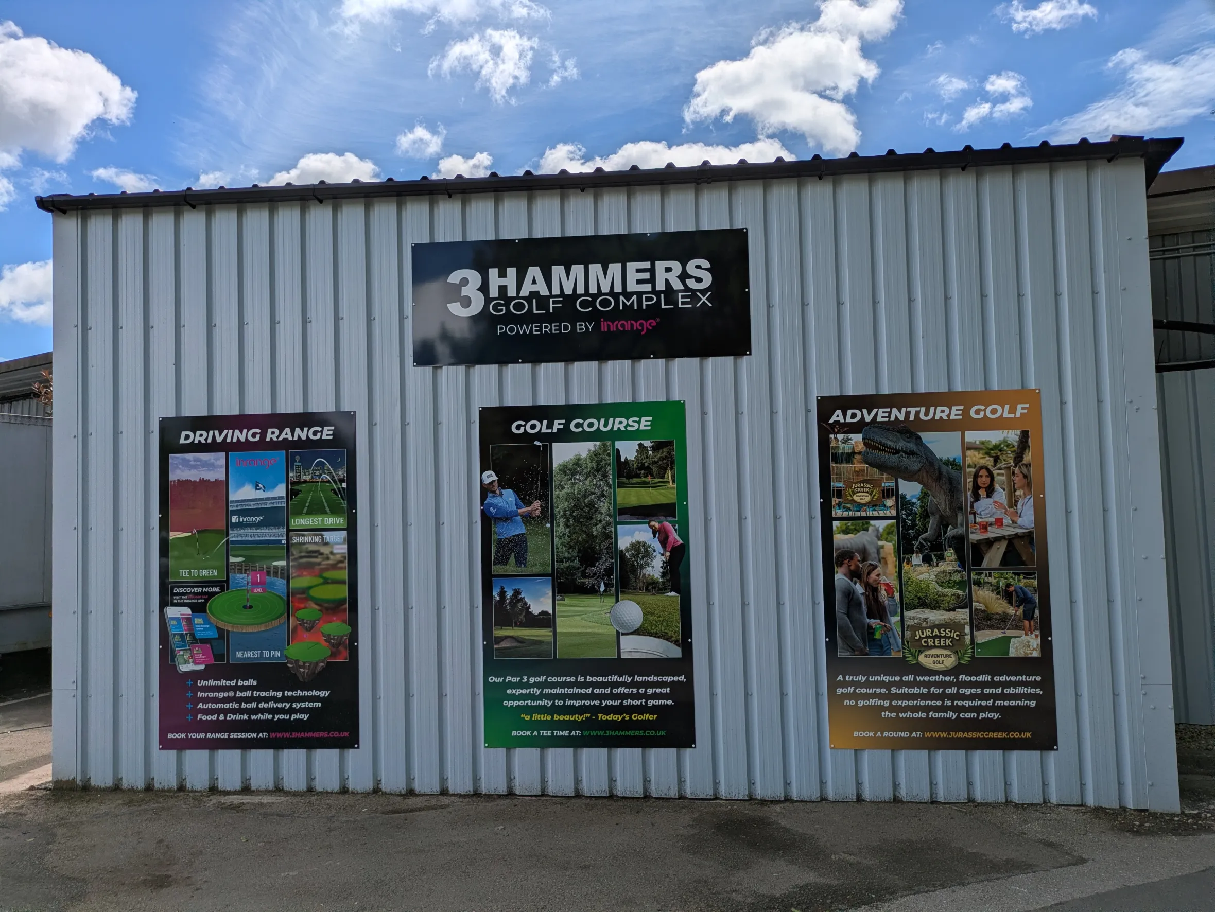 Three posters on a corrugated metal wall advertising 3 Hammers Golf Complex, showcasing driving range features, a golf course, and adventure golf.