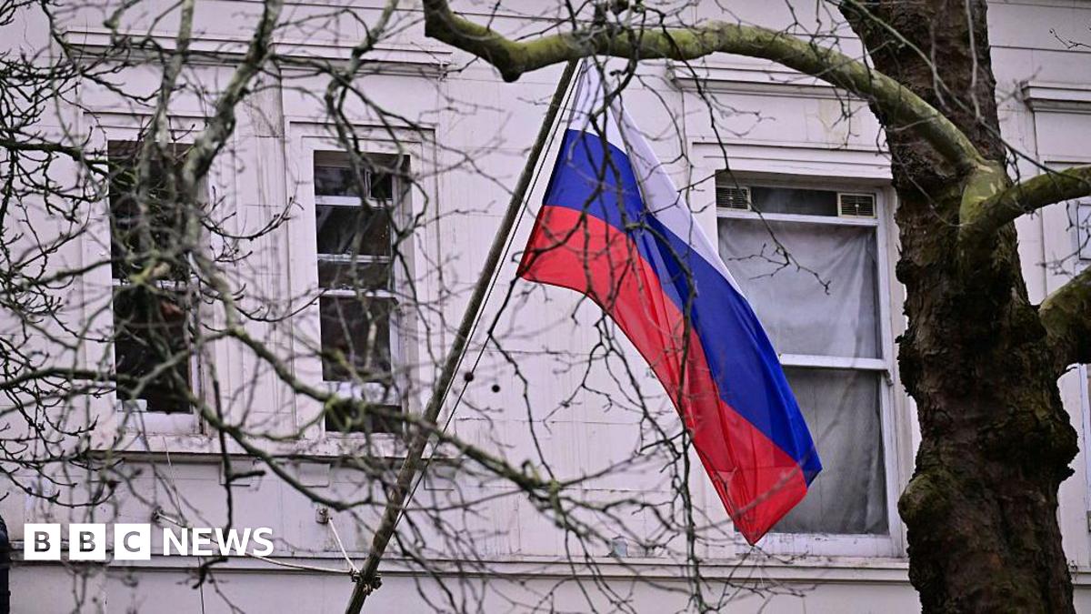 A Russian flag is visible through trees