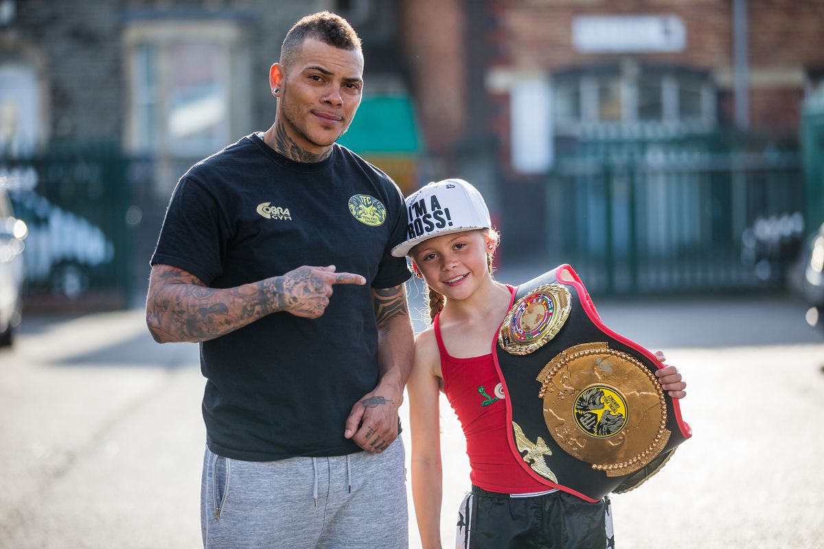 Tiah Ayton, 10, who is world kickboxing champion for her weight, pictured at a gym in Kingswood, Bristol with her father Mike. See SWNS story SWFIGHT; Meet the toughest kid in the world - little ten-year-old Tiah Ayton the WORLD'S best junior kickboxer who dreams of becoming an ultimate FIGHTER. The pocket rocket took up kickboxing four years ago after her parents noticed she enjoyed play fighting with little sister. Her coaches were instantly impressed and within months she was fighting BOYS who were three years her senior just to get a fair match. Nicknamed 'Girl On Fire', the determined fighter has already caught the eyes of the Team GB Olympic squad.