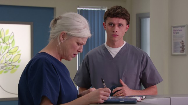 Jacob anxiously looks on as Doctor Todd reads her notes