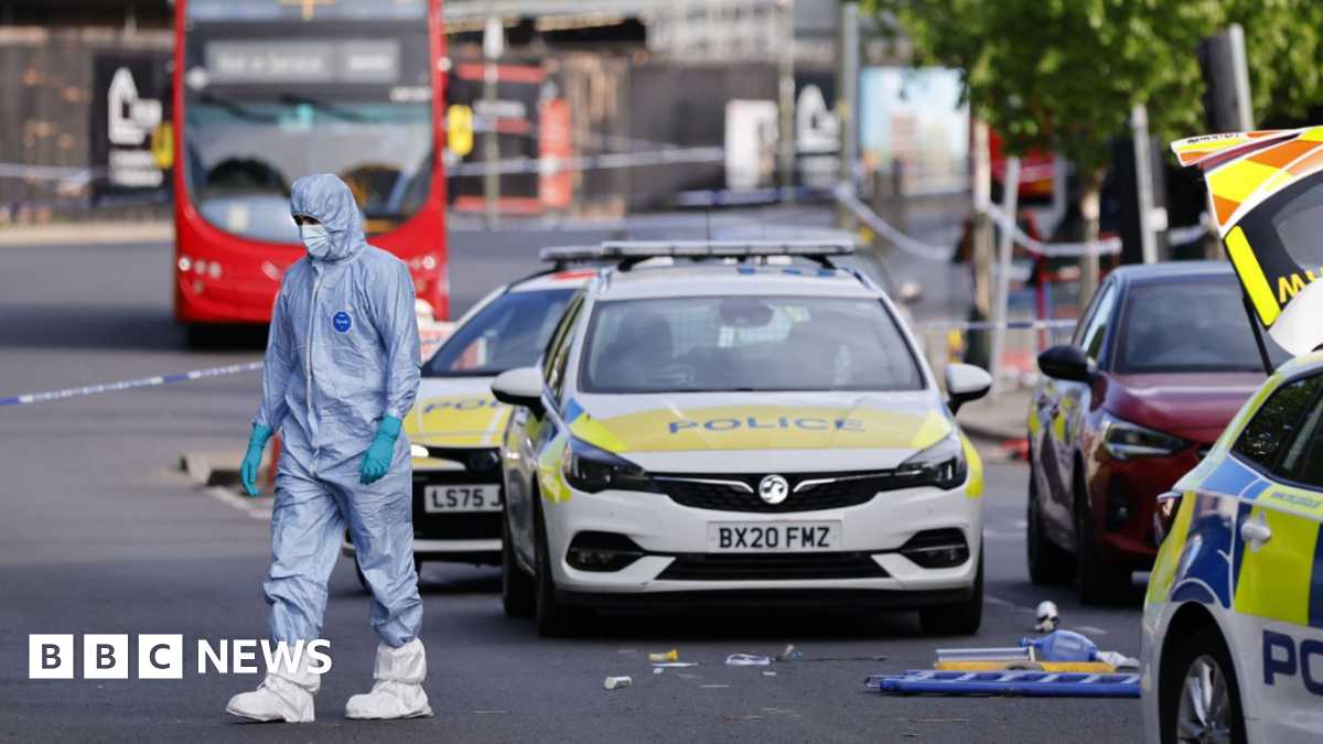 Forensic police officers inspect the scene where two Jewish men are seriously injured after being stabbed in Golders Green