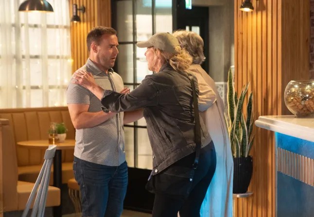 Cassie tries to hug a stunned Tyrone as Evelyn looks on